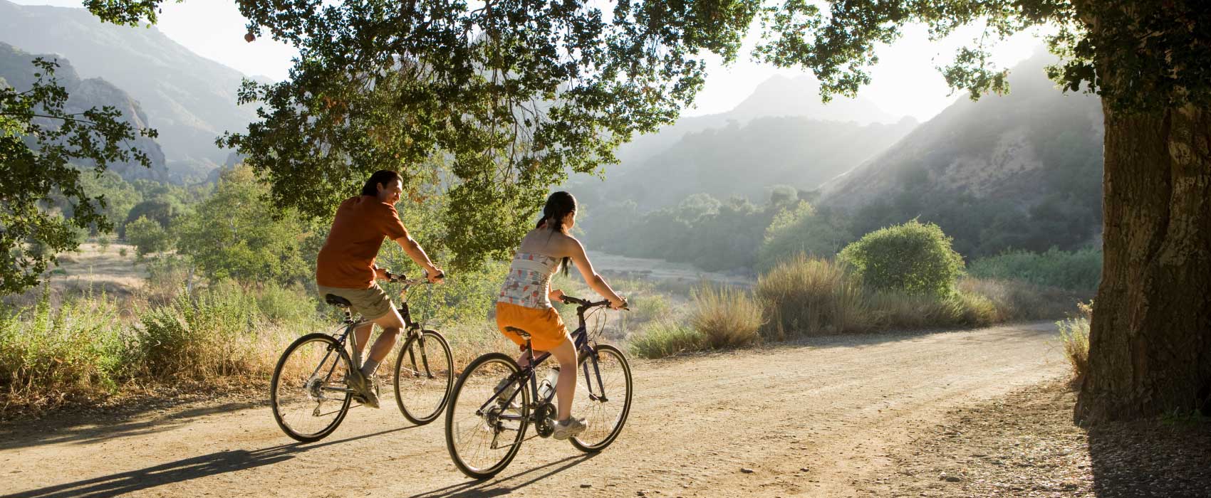 two people riding bikes through beautiful landscape