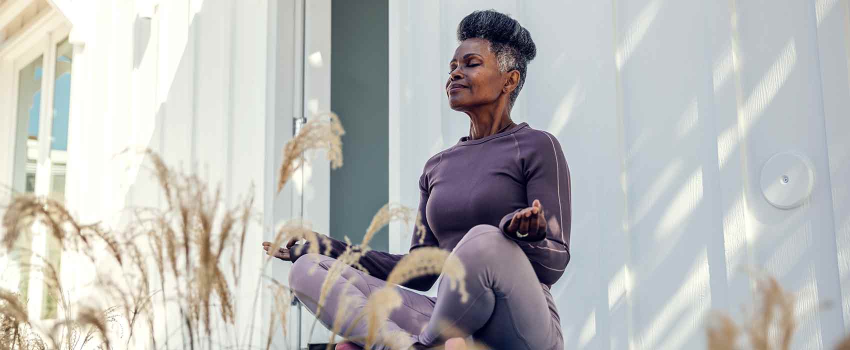 Woman meditating outside.