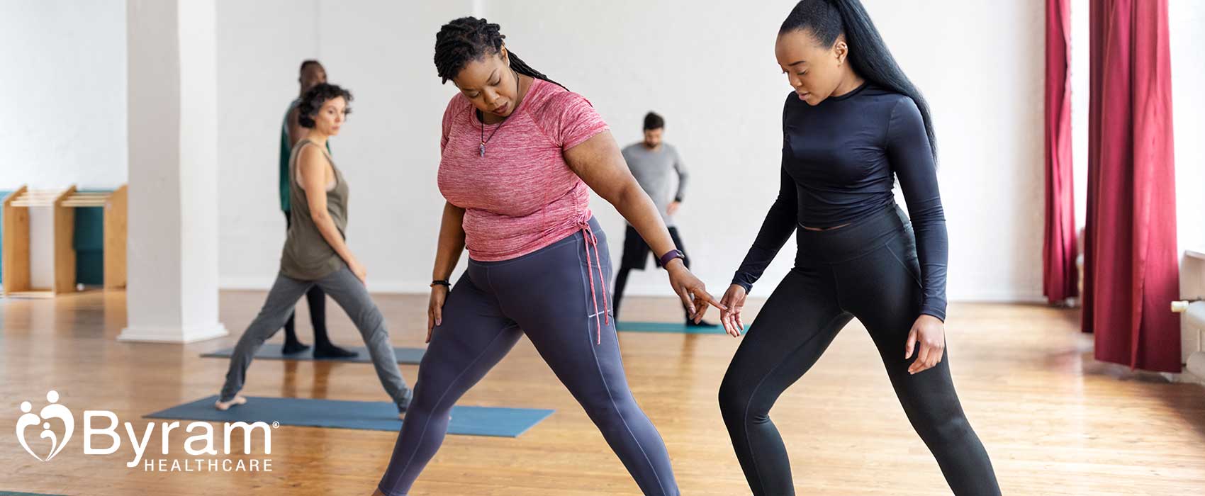 Woman taking a workout class with instructor.