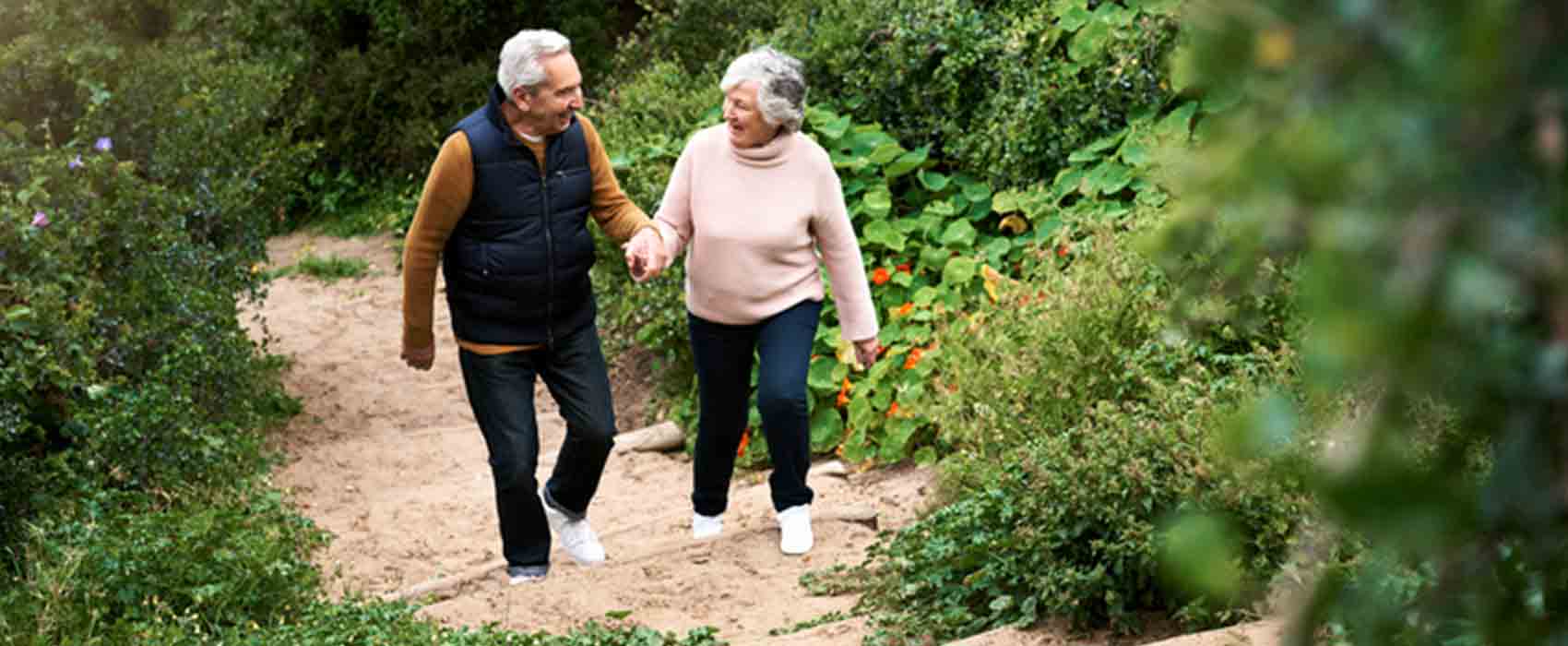 Older man and woman taking a nature walk.
