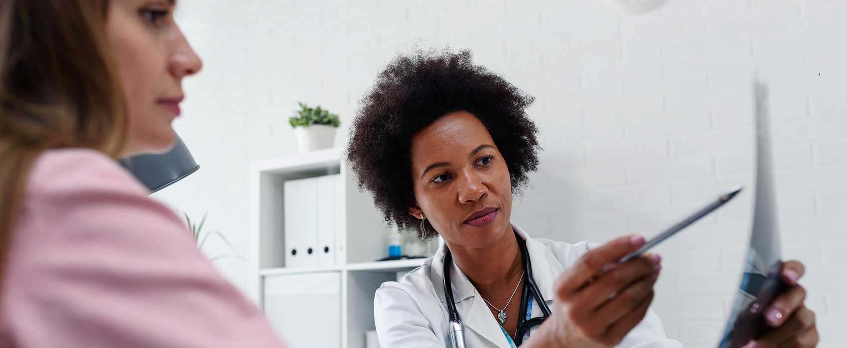 breast cancer screening review with doctor