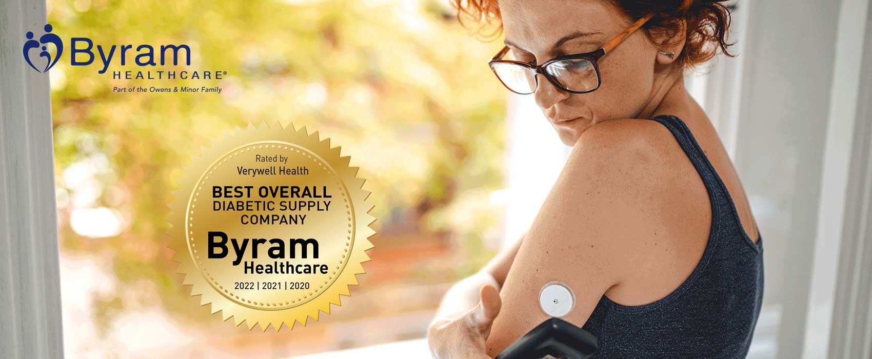 Woman using her continuous glucose monitor.