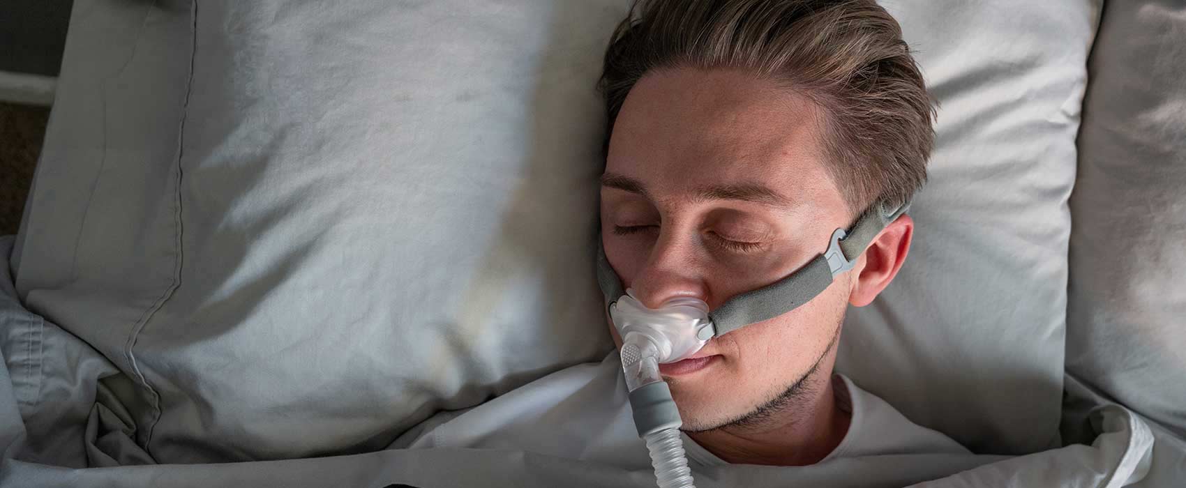 Man sleeping with a CPAP machine.