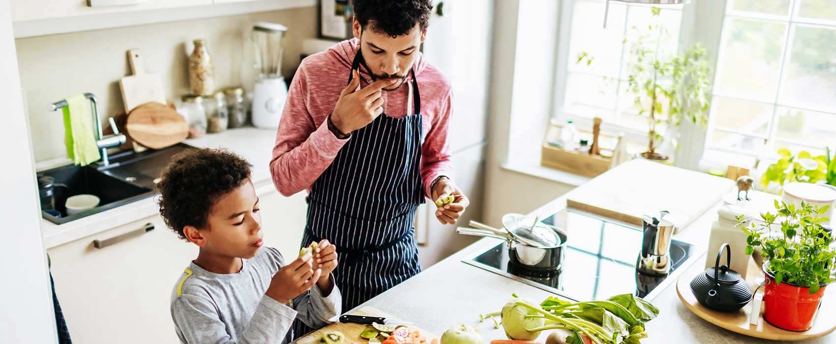 Father and son eating and cooking.