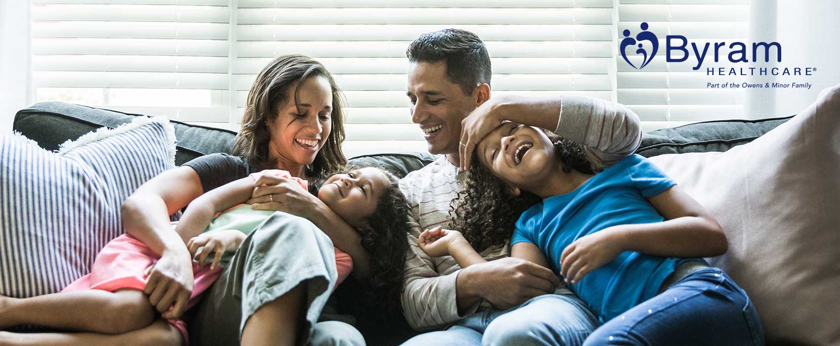 Happy family sitting on a couch.