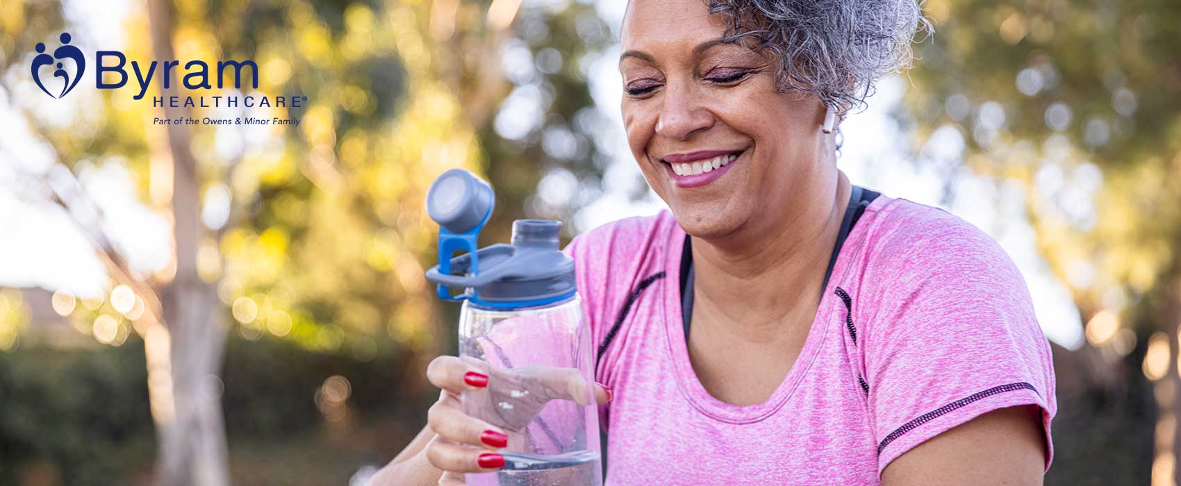 older woman holding water bottle