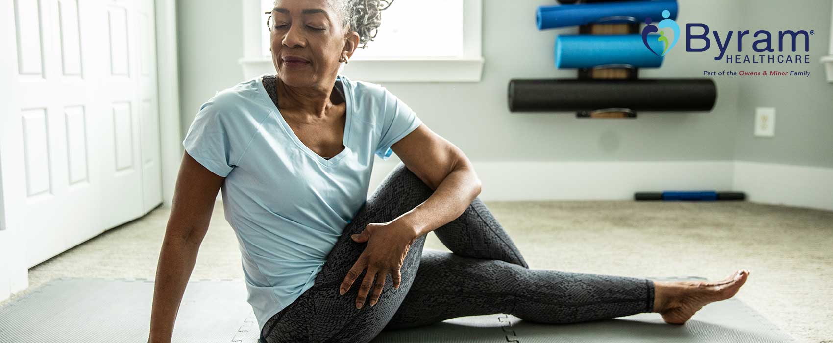 Older woman stretching on a mat.