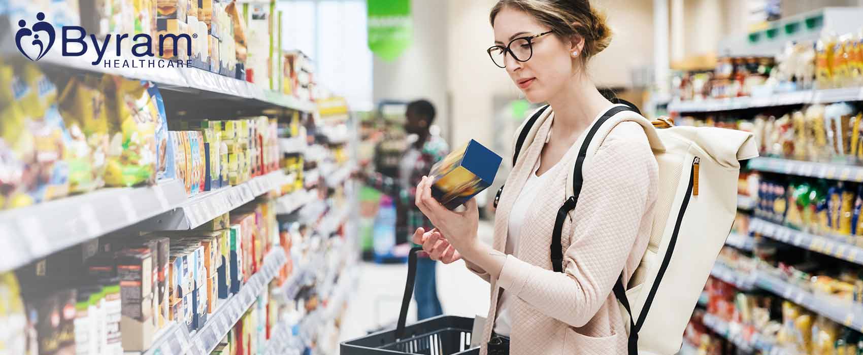 Woman looking at a can of food in a grocery store.