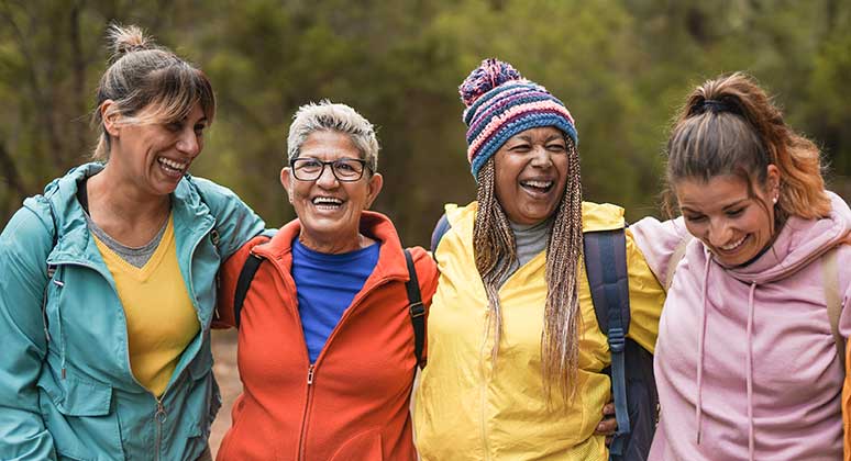 Women laughing and hiking.