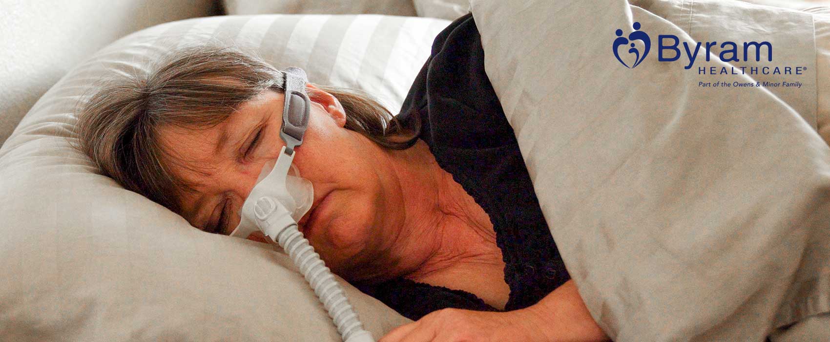 woman in bed with c-pap mask