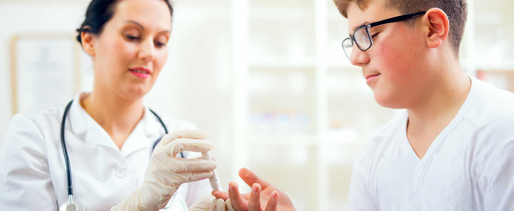 Doctor testing a patient's blood sugar.