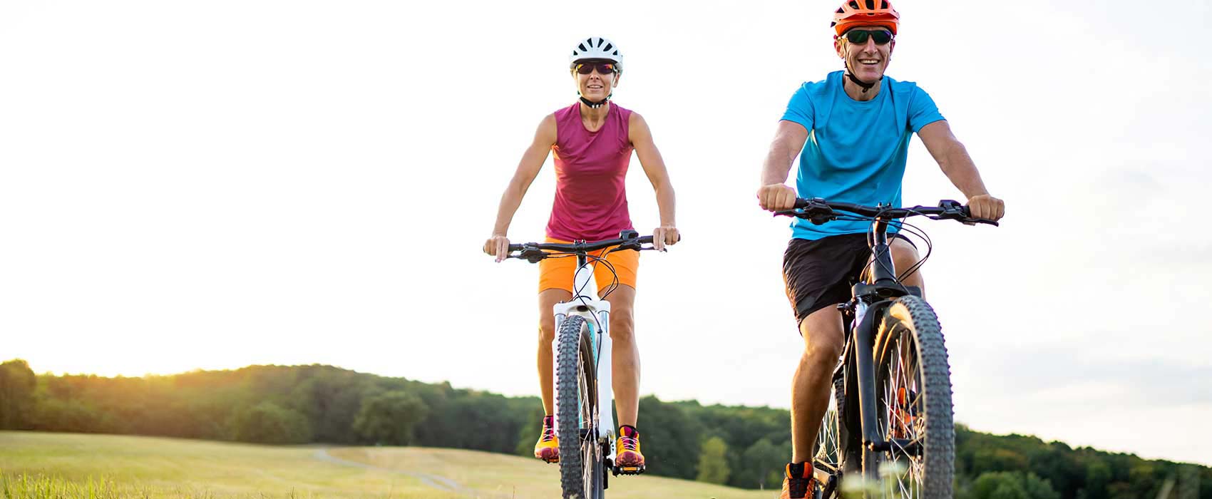 Man and woman riding bikes.