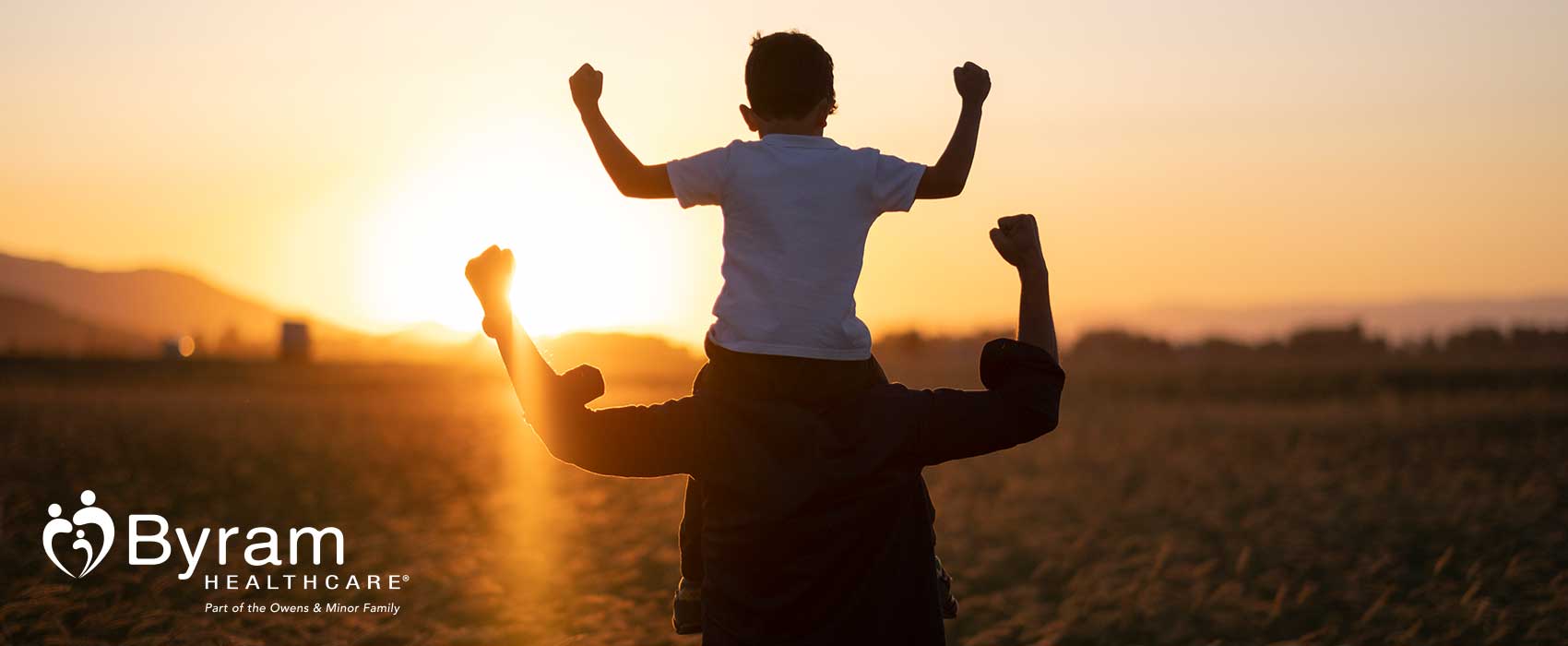 Father walking with son on his shoulders.