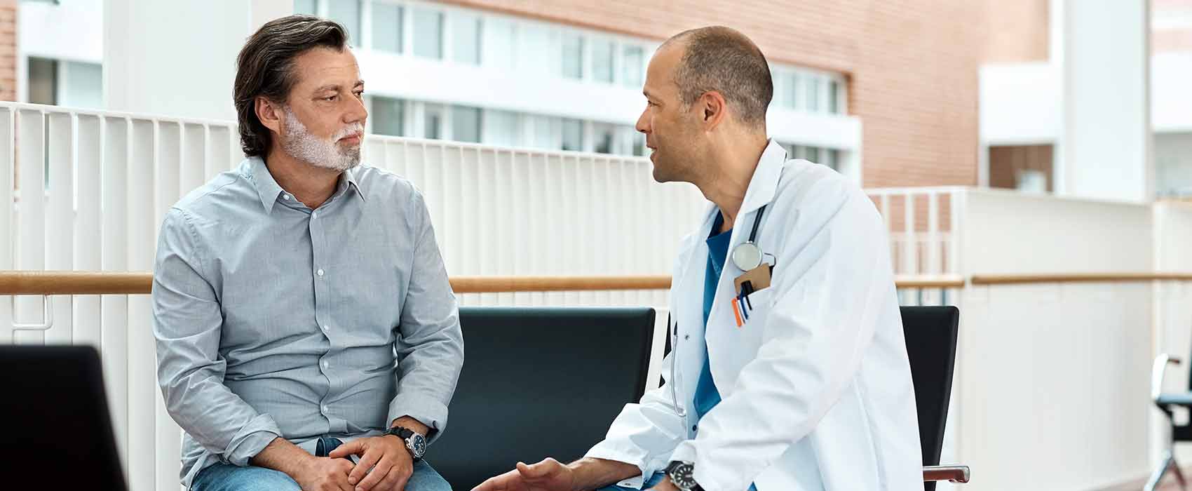Doctor talking to his patient about testicular cancer.