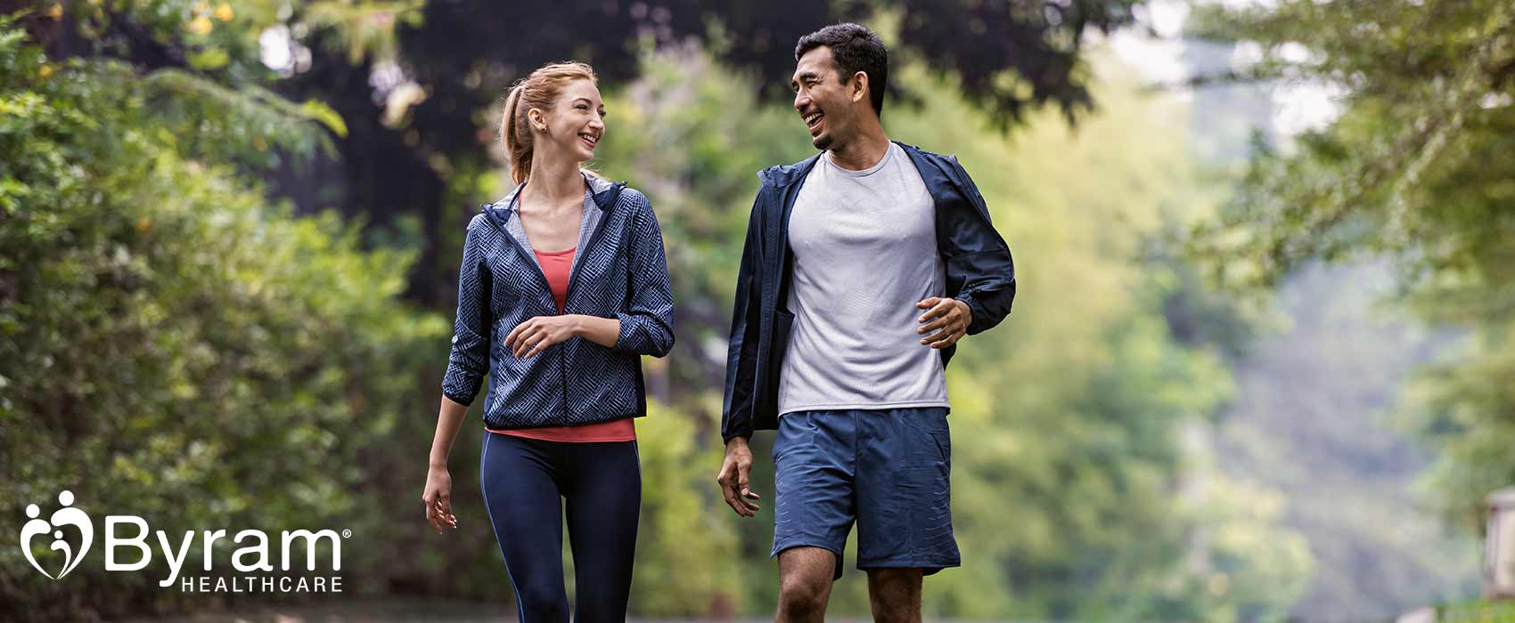 Man and woman walking down a road.