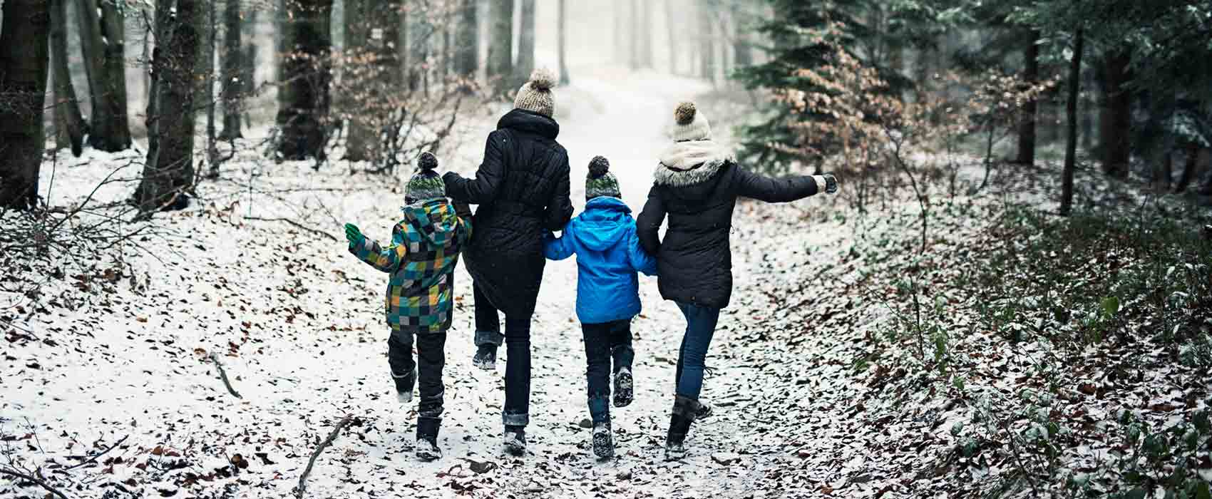 family walking along snowy path
