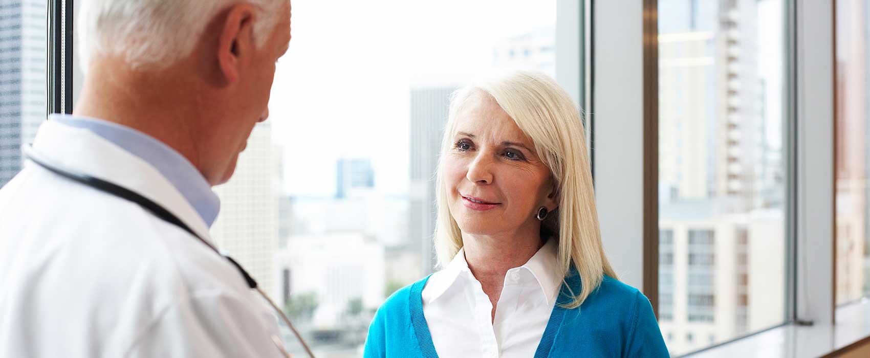 Urologist talking to his patient about medicaid.