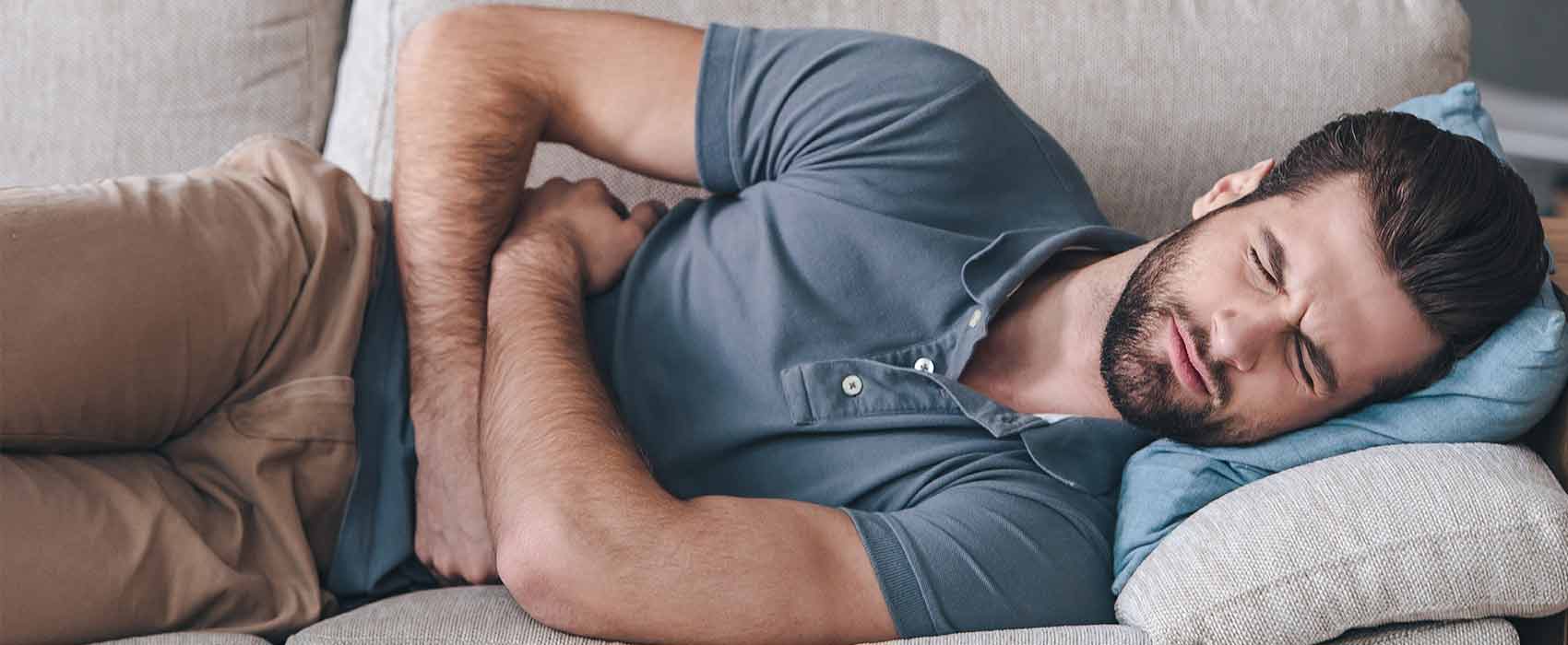 Man holding his stomach from kidney pain.