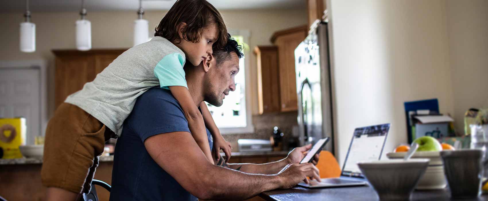 Dad with his son looking at a computer.