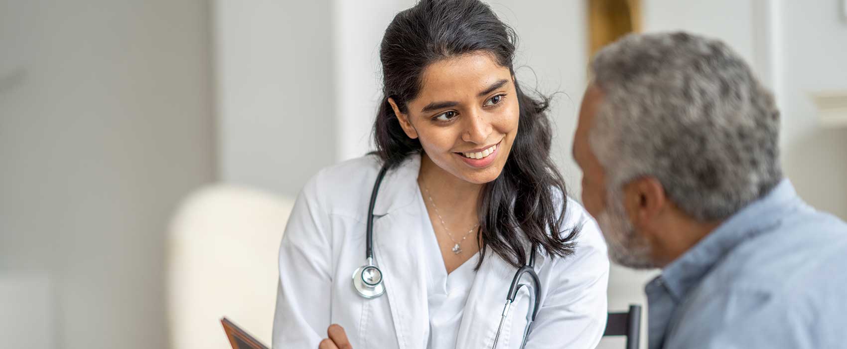 Doctor talking to her patient about intermittent catheters.