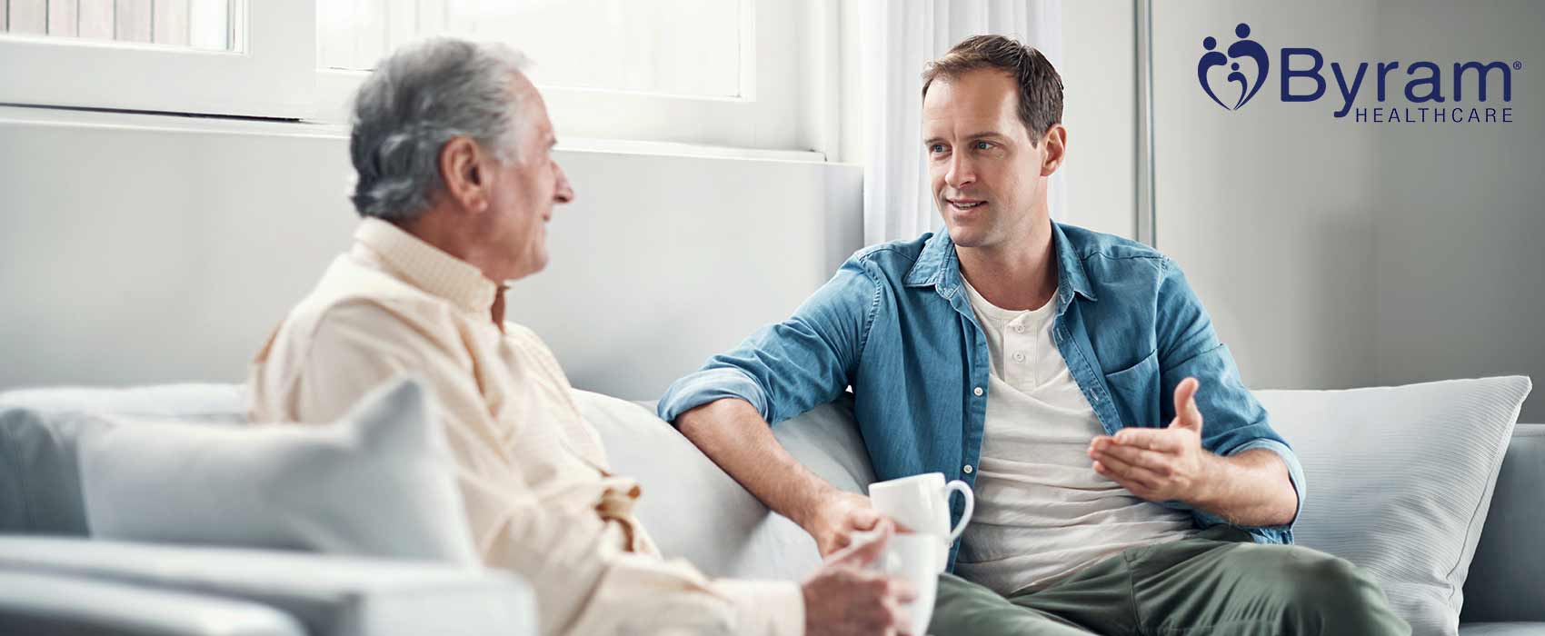 Father and son sitting and talking about family health history.