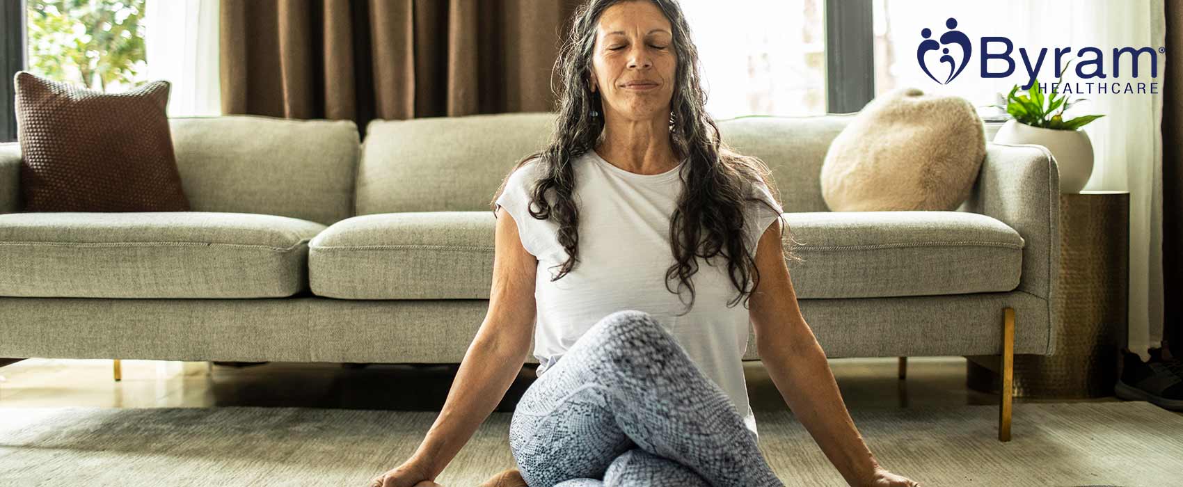 Woman meditating in her home.