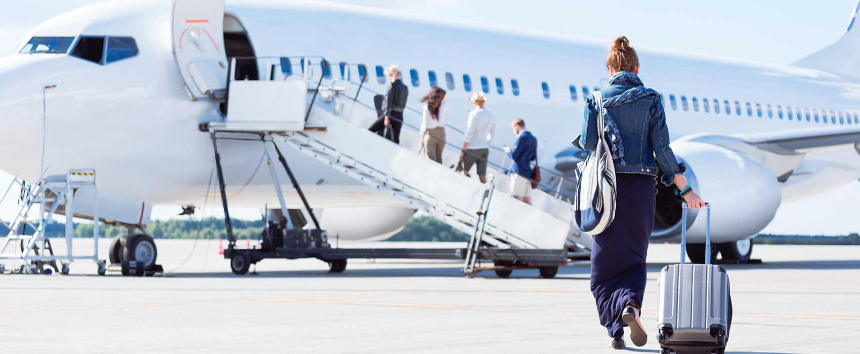 Woman getting on an airplane.