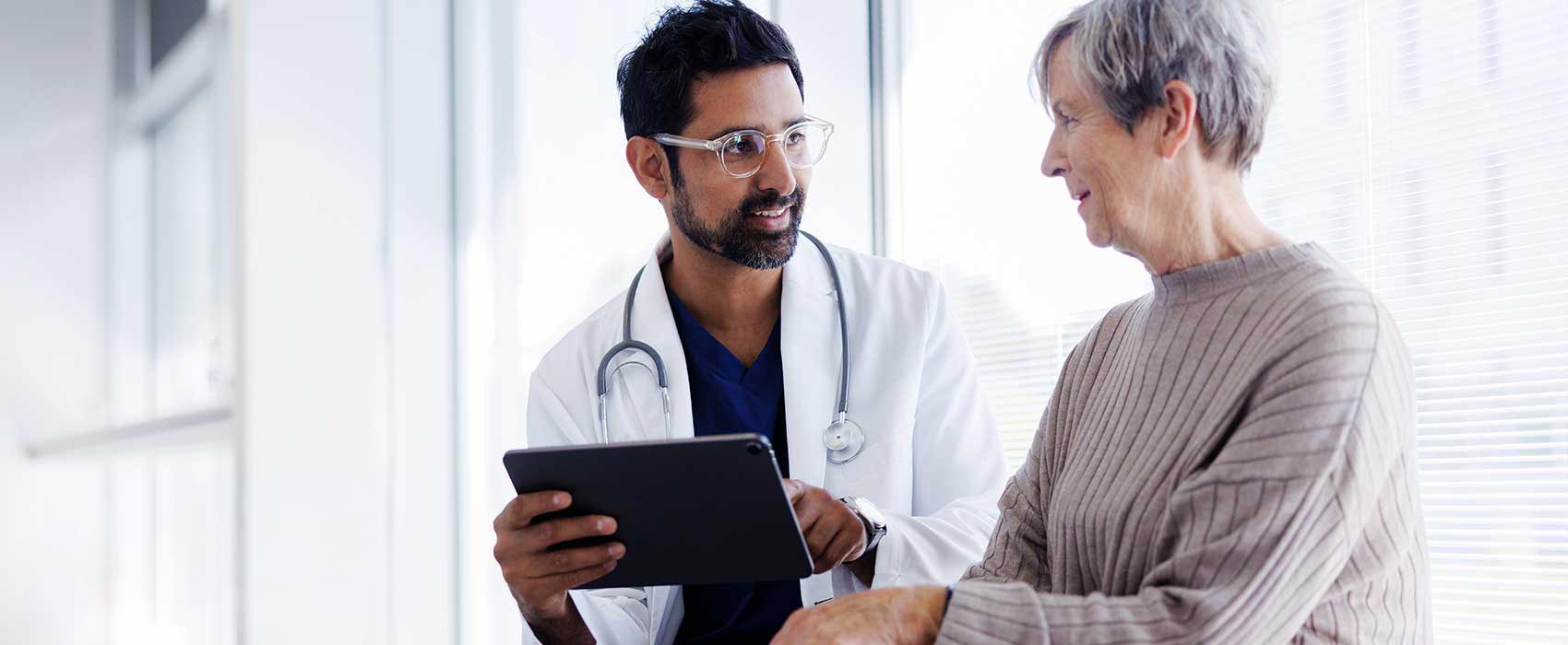 Doctor talking to his older patient.