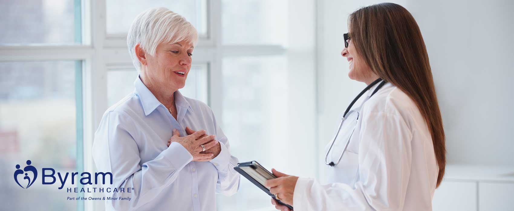 grey-haired woman talks to her doctor