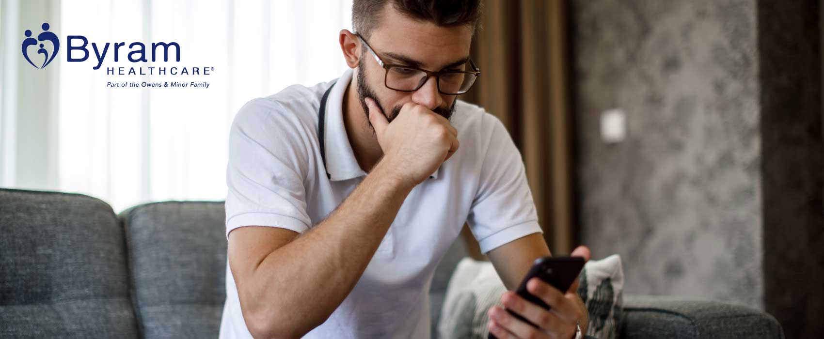 man sitting looking at phone