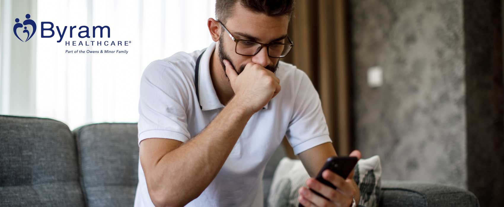 Man sitting on his couch looking frustrated.