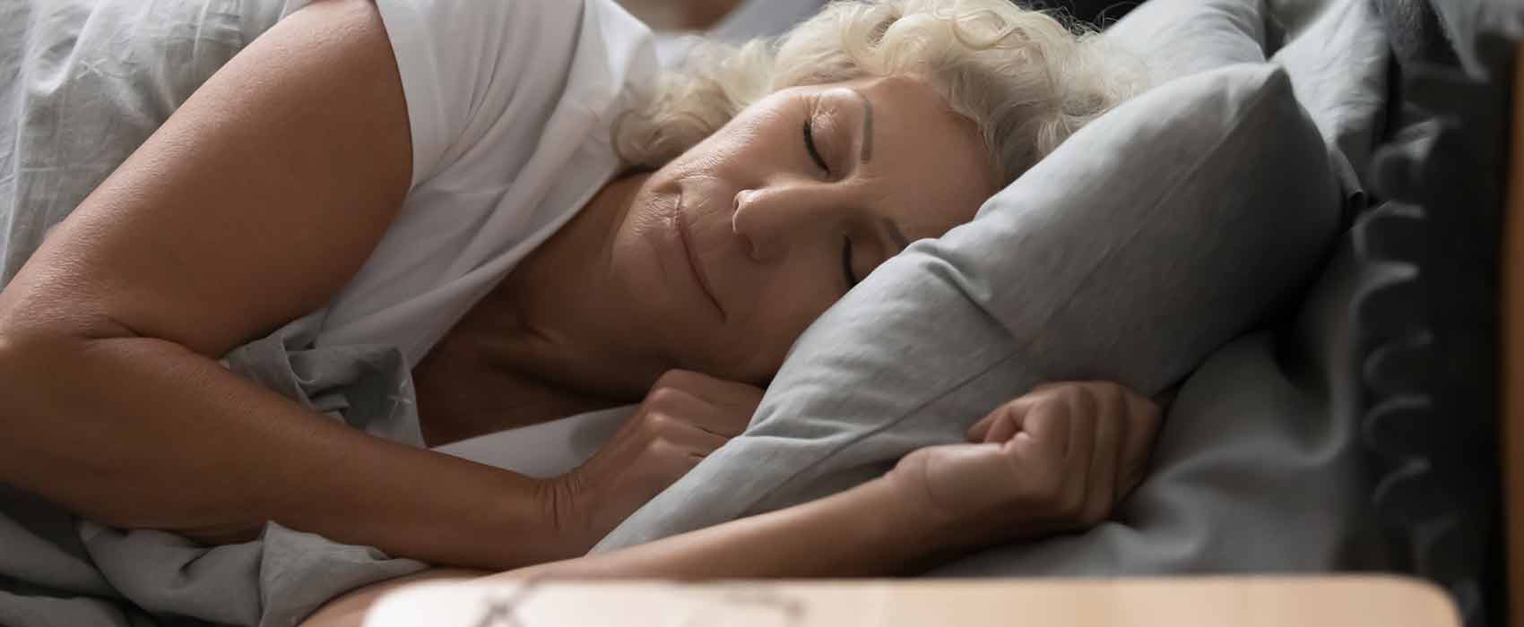 Older woman sleeping on her side.