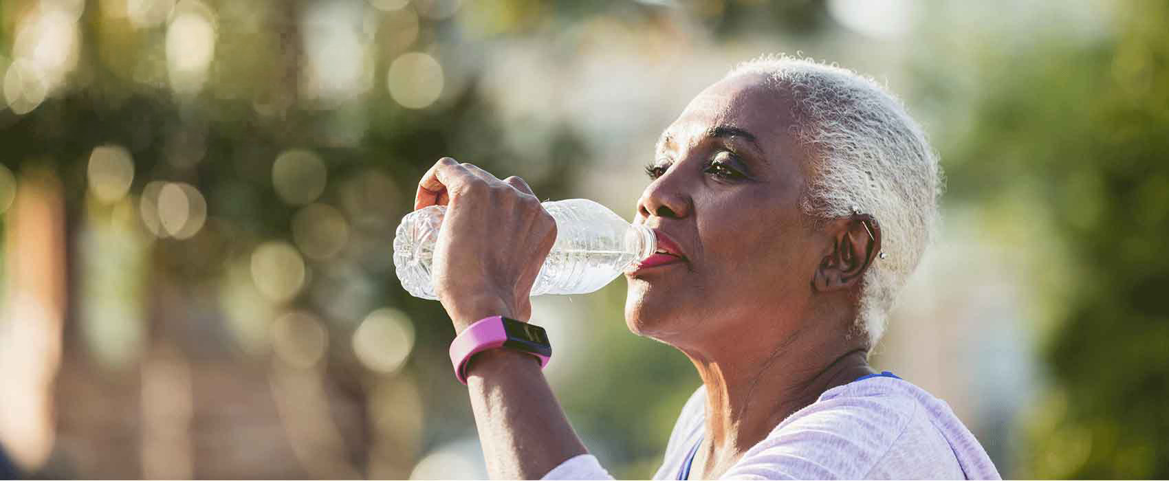 Woman Drinking Water Outdoors