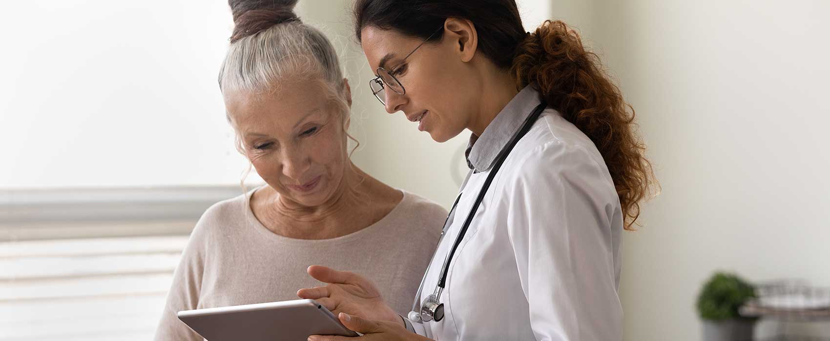 Older woman talking to her doctor.