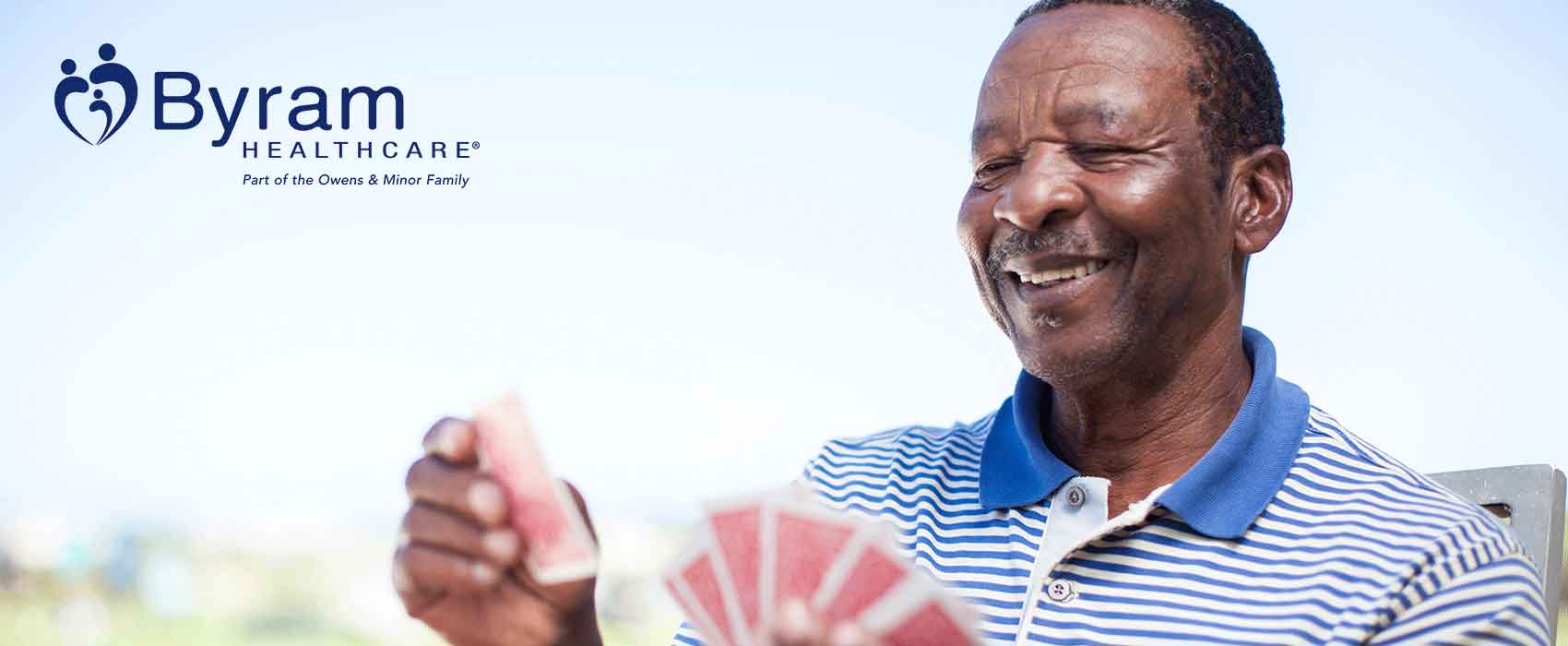 Smiling Man Playing Cards Outside