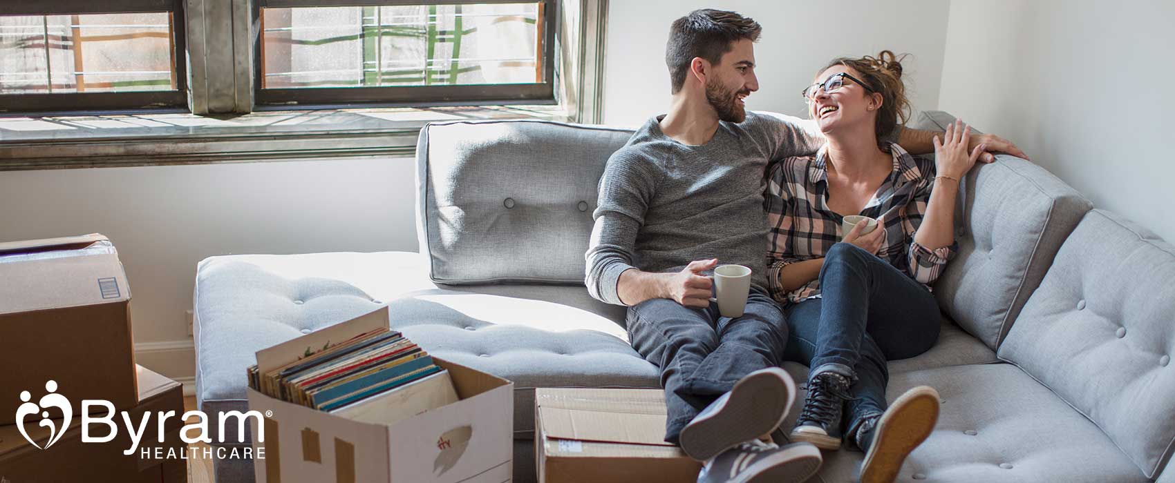 Couple sitting together on a couch in a new home.