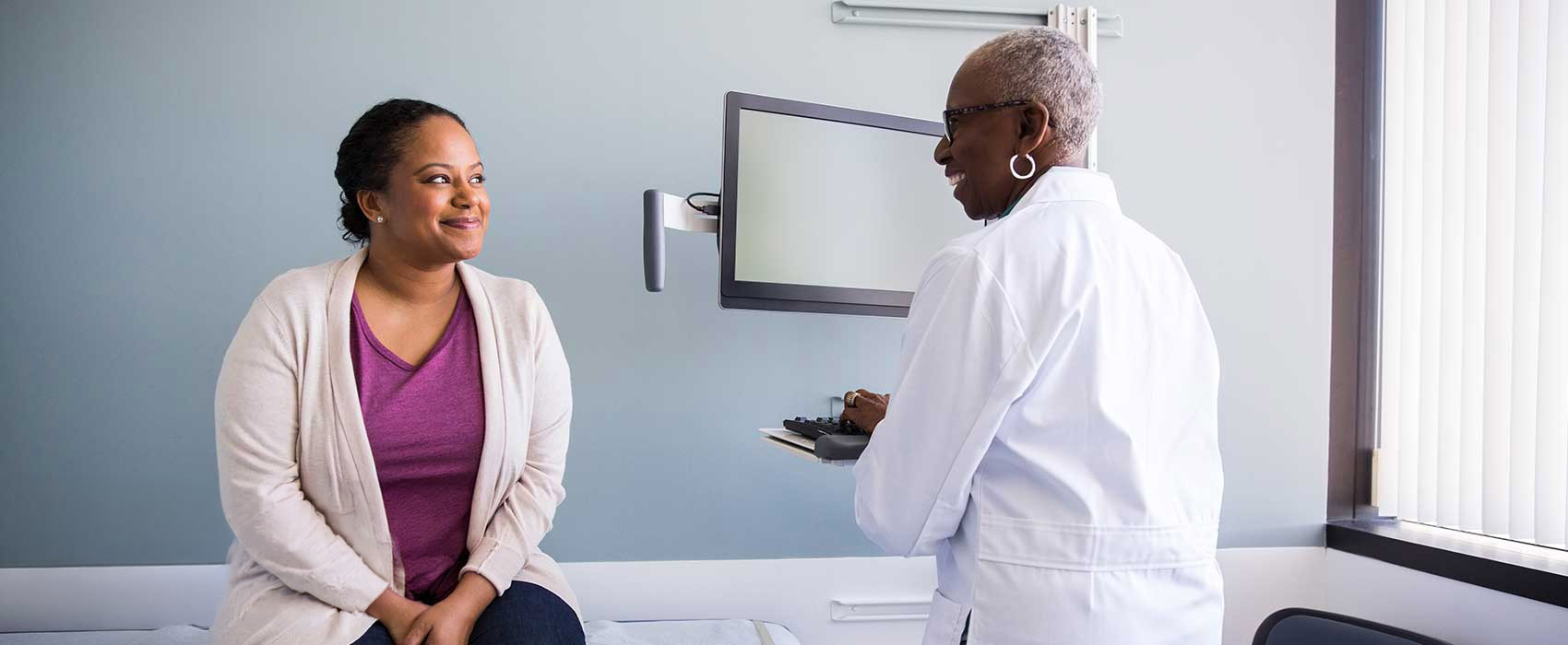 Woman talking to her urologist.