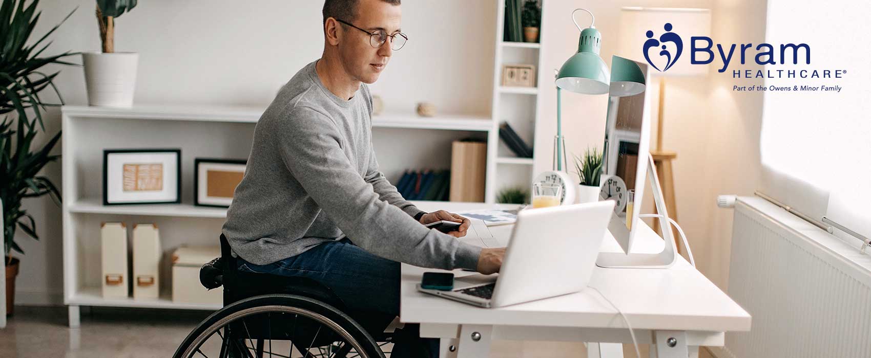 Man working at his desk in a wheelchair.