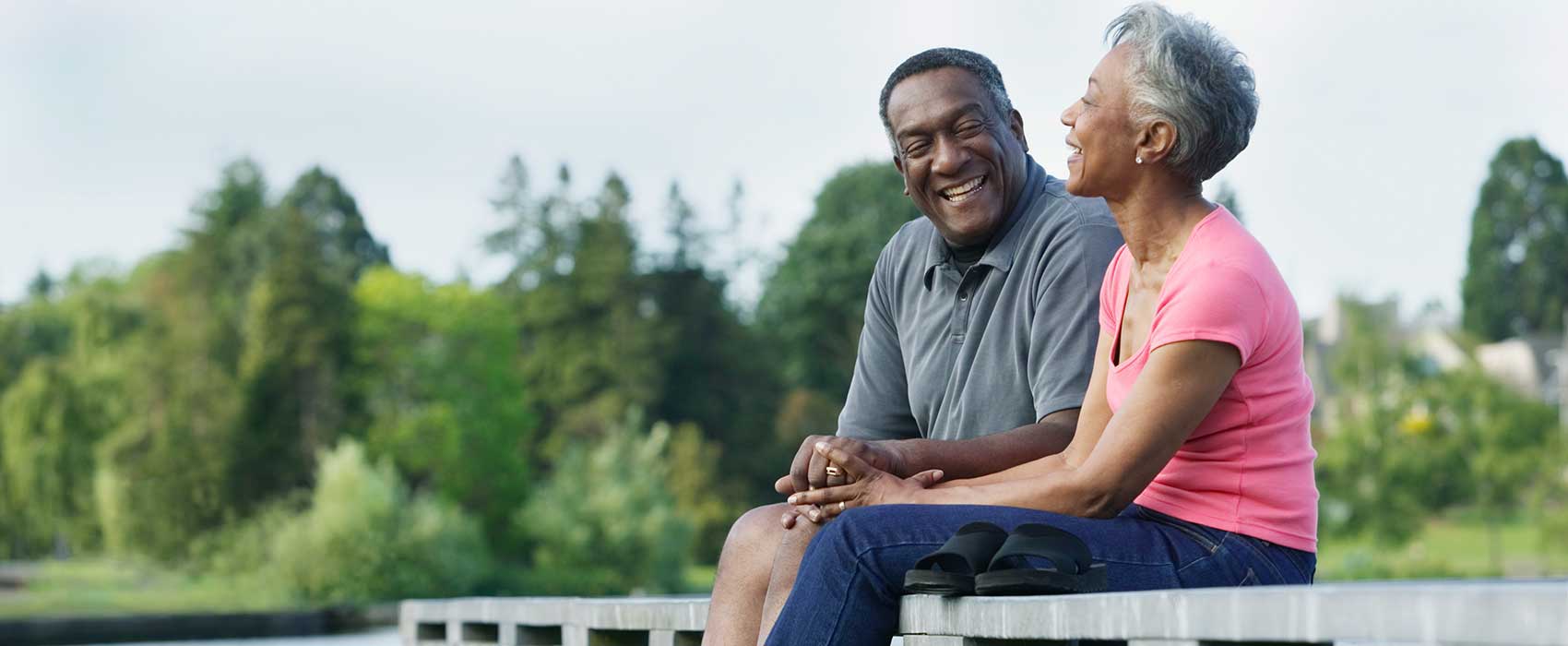 older couple sitting outside smiling