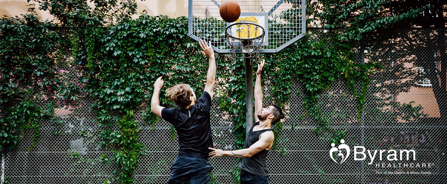 Two men playing basketball