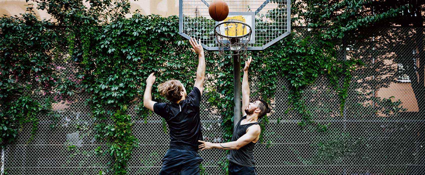 Two men playing basketball