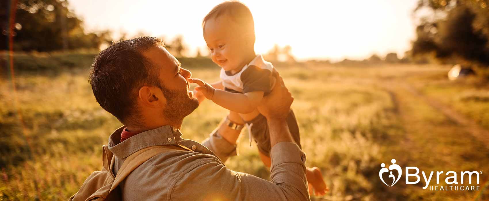 Father holding up his son.