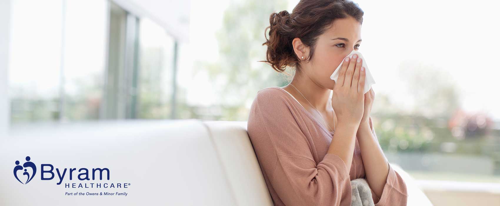 Woman blowing her nose.