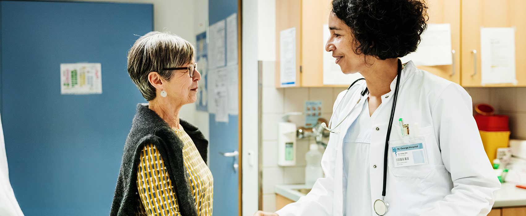 Urologist talking to her patient.