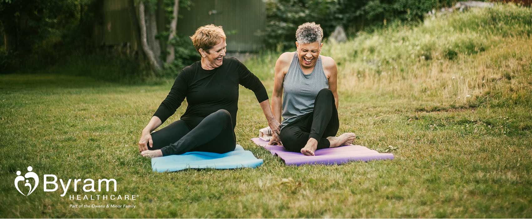 Two older women doing yoga.