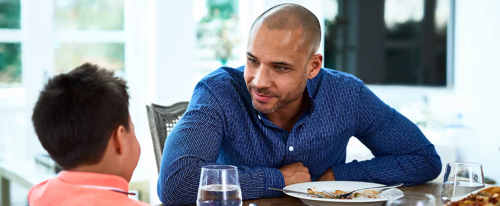 Father and son at the dinner table.