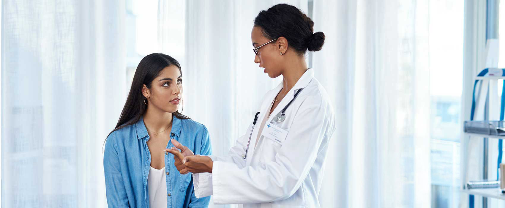 Urologist talking to her patient.