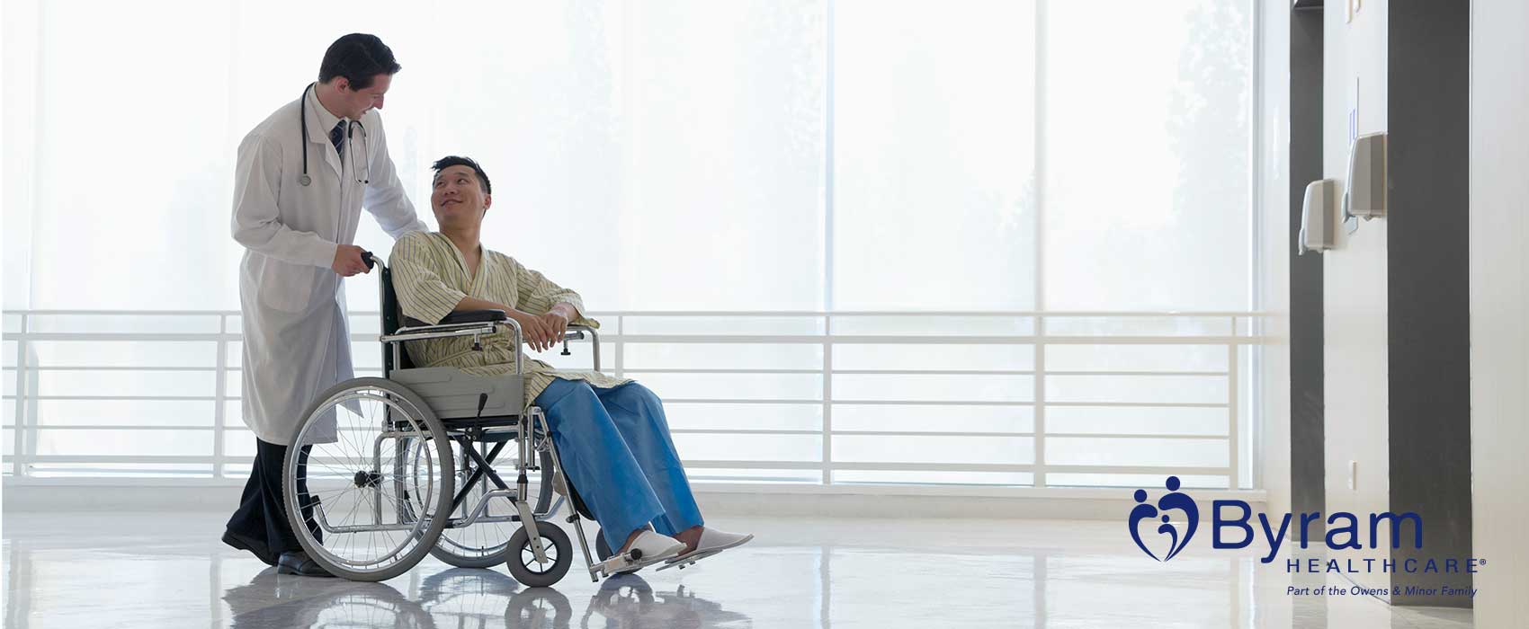 Nurse pushing patient in a wheelchair after surgery.