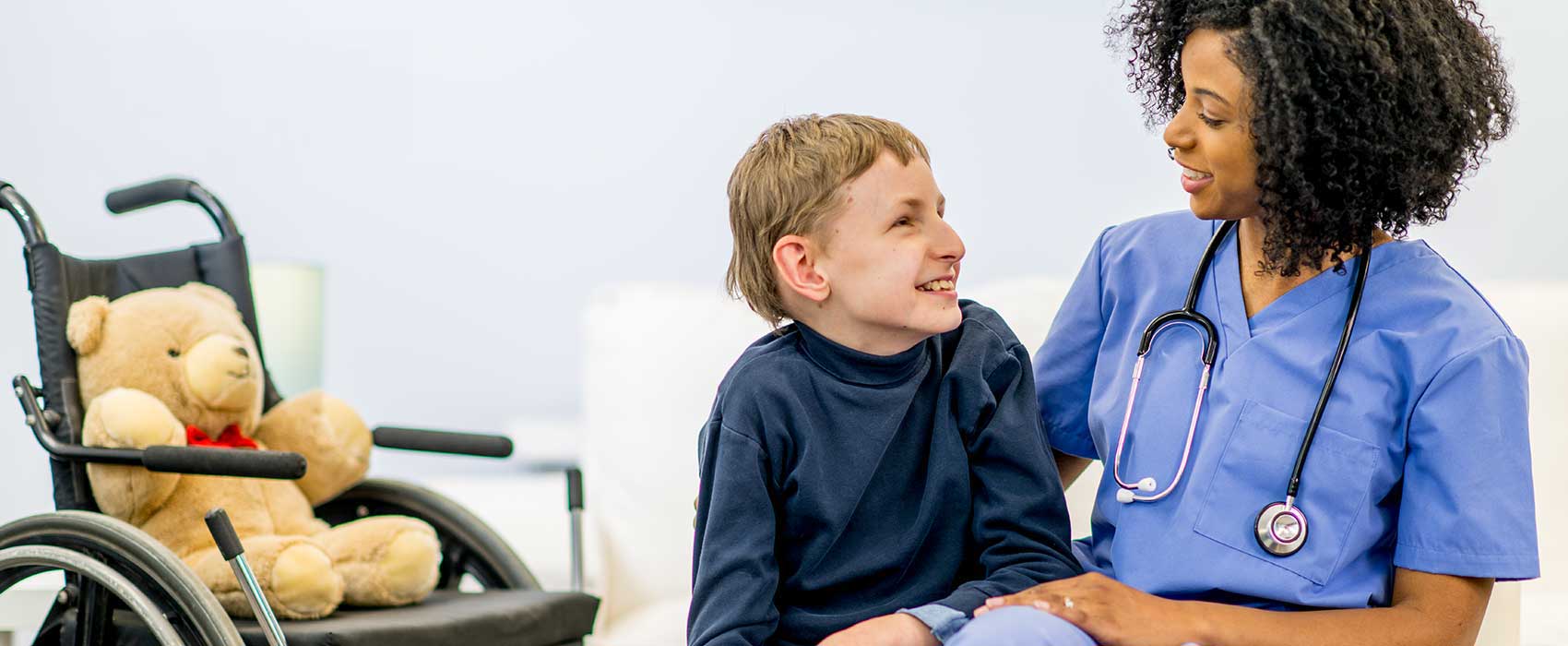 Young boy talking to a nurse