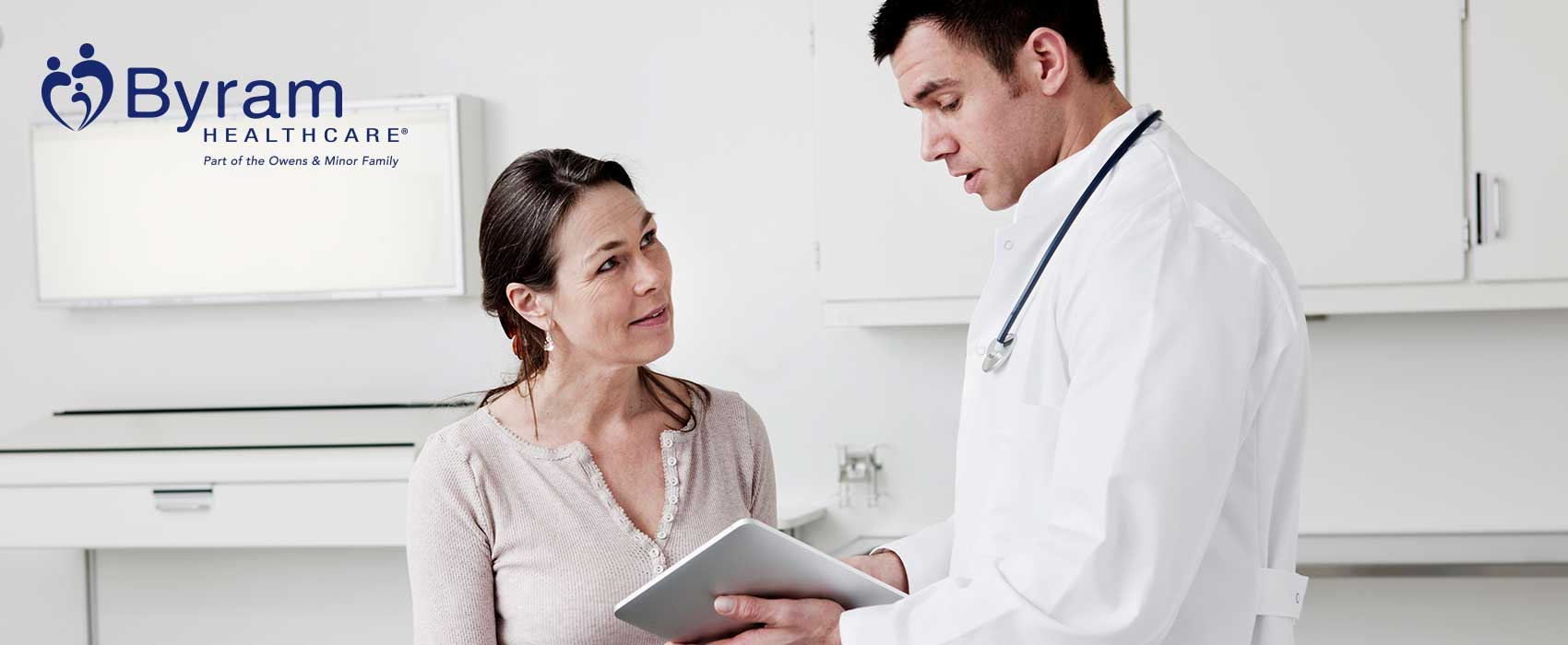 Doctor showing his patient information on a tablet.